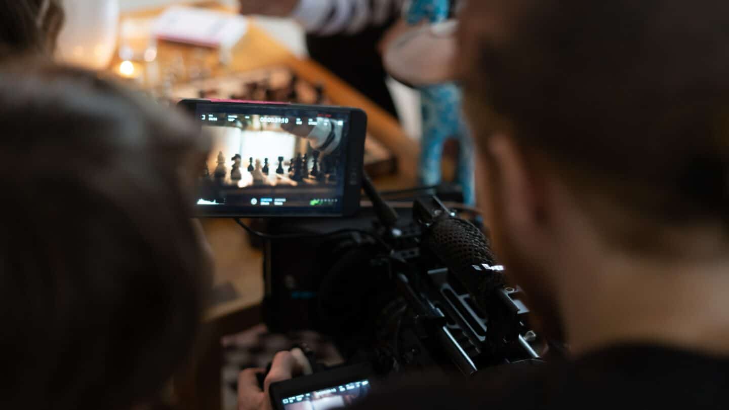 view from over shoulder of cameraman looking at camera screen videographer uk